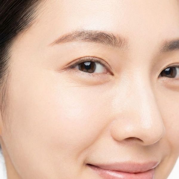 Smiling woman with smooth skin around her eyes and minimal crow's feet.