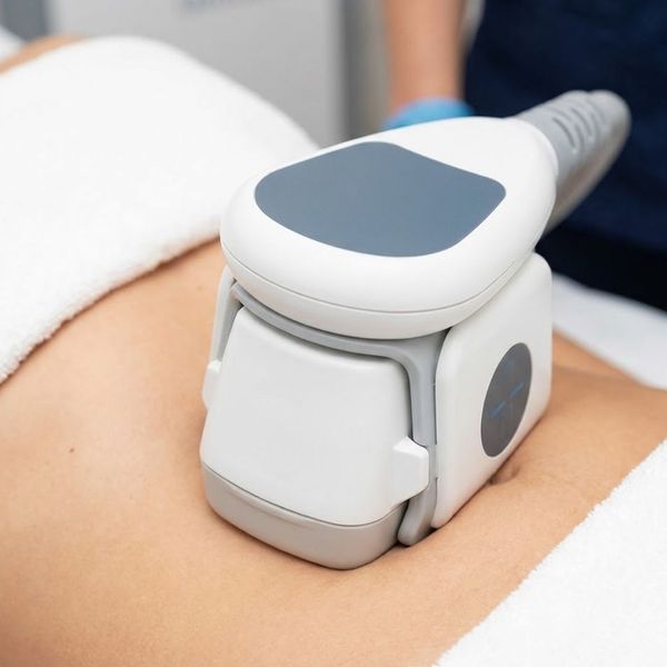 Emsculpt device applicator applied to a patient's abdomen.