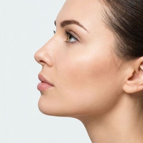 Profile view of a woman with a defined and sculpted jawline.