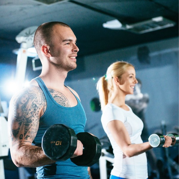 a man and woman doing barbell curls together