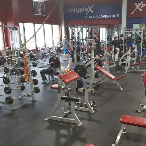 a large room of benches and bar weights