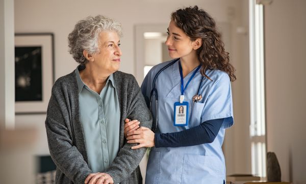 nurse and woman in assisted living