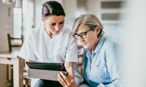 nurse and patient looking at tablet