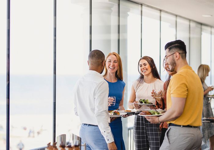 group of people gather with food at event