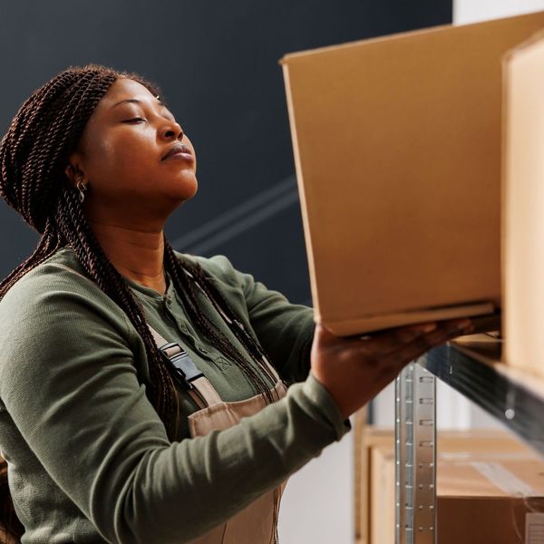 woman taking a box off of a shelf