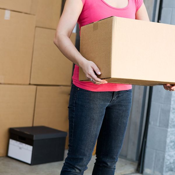 woman pulling a box out of storage