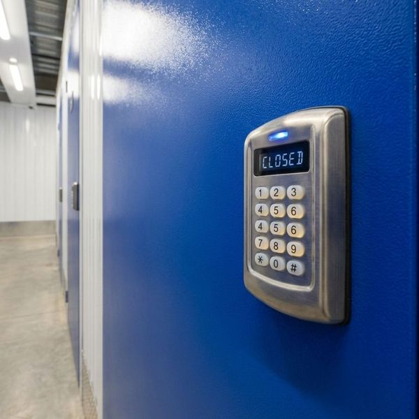 A close-up of an electronic keypad lock on a blue storage unit door.