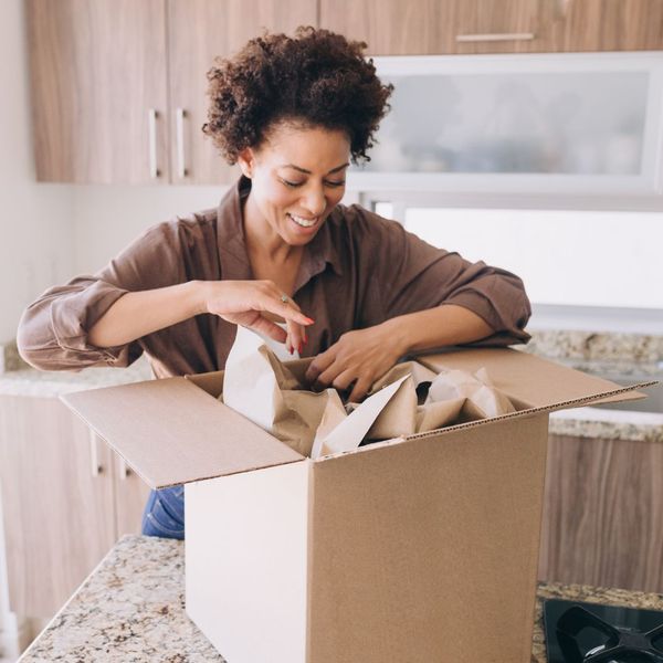 woman placing items in a box