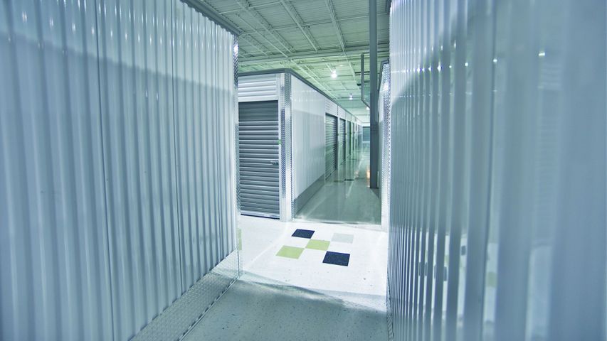 A bright and secure hallway inside a modern self-storage facility.