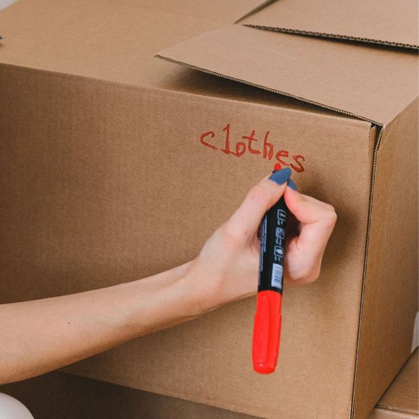 person labeling a box
