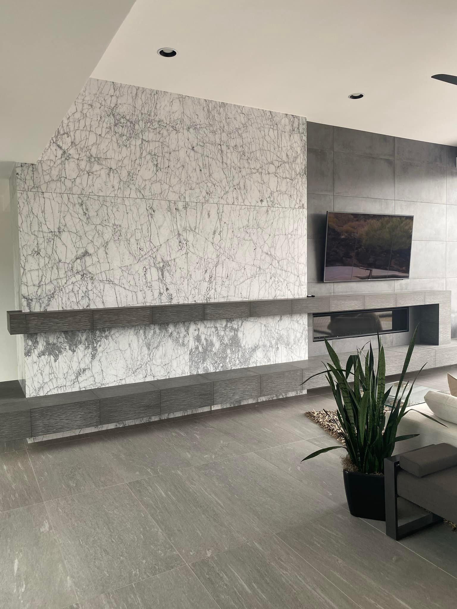 A modern living room with a custom tile fireplace wall, a floating hearth, and a linear fireplace. Custom Fireplace