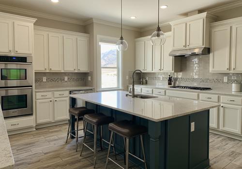 Custom Kitchen Renovation with White Cabinets and Teal Island in St. George, UT.