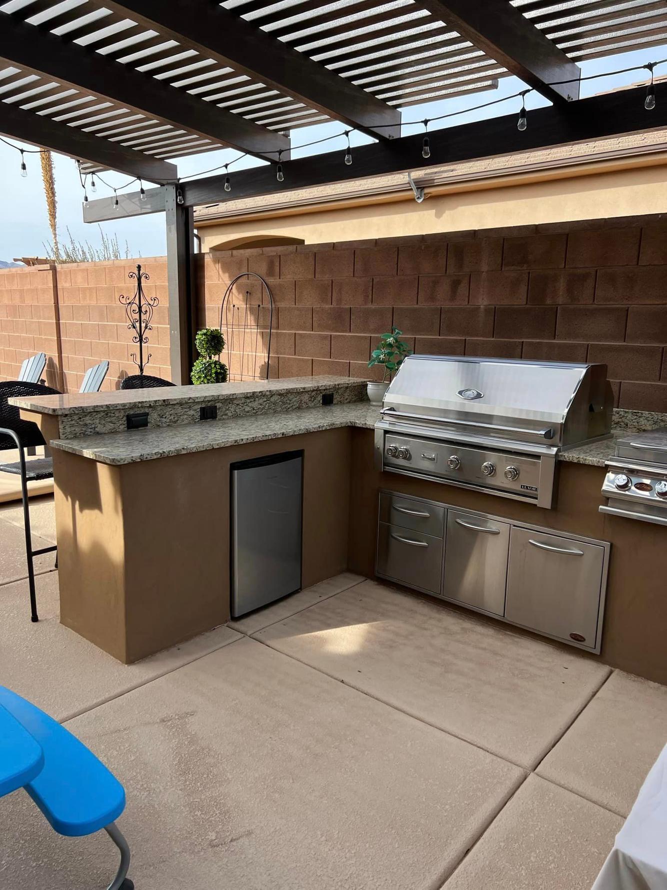 Built-in Outdoor Refrigerator and Grill under a Pergola