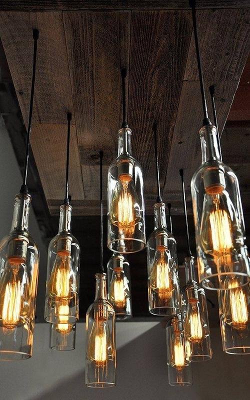 Custom light fixtures made from wine bottles in a rustic-style home, adding unique character to the space. Custom light fixtures made from wine bottles in a rustic-style home