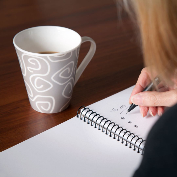 Woman with coffee making a list