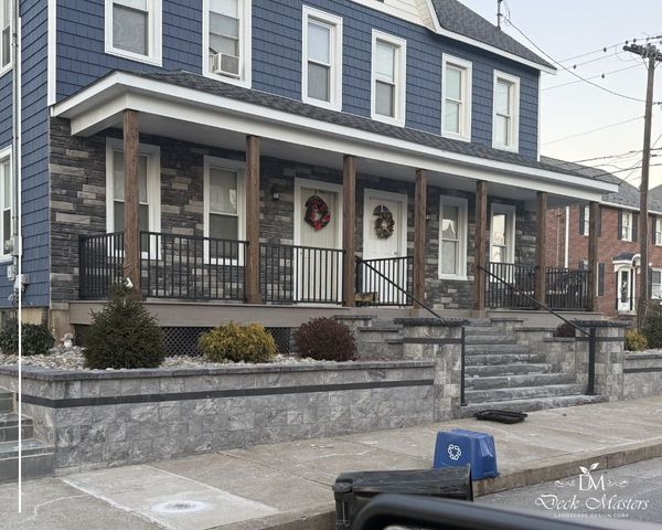 elaborate front porch and railing, stone stairs