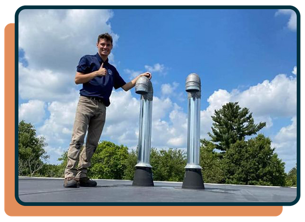 professional standing next to clean dryer vent