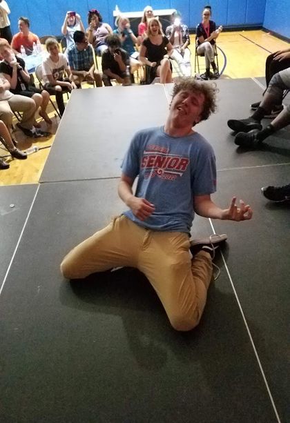 image of a hypnotized person pretending to play air guitar