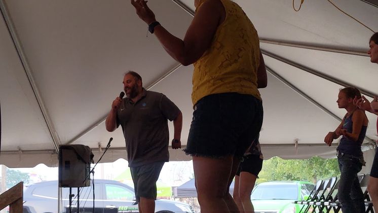 image of a man singing on stage with people pretending to play instruments