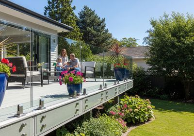Family enjoys time on deck with glass railing