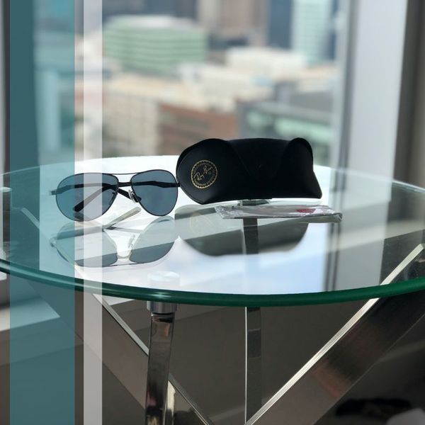 Glass table with sunglasses on top of it