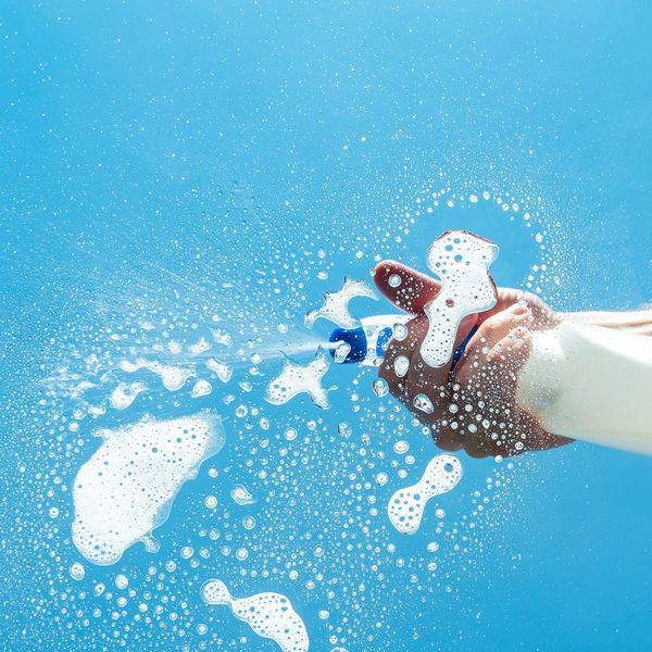 person cleaning glass