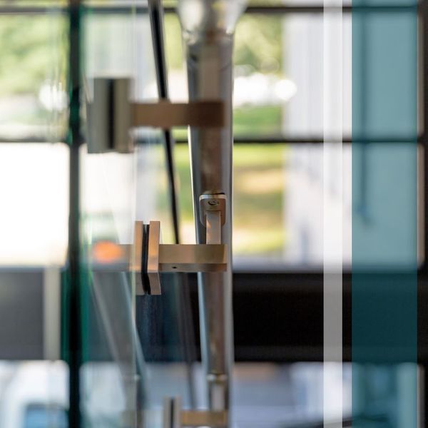 handle of glass stairway railing