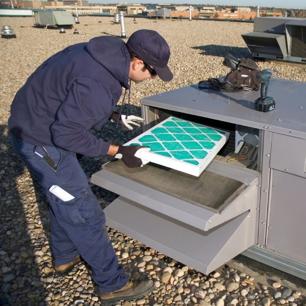 HVAC technician changing a filter HVAC technician changing a filter