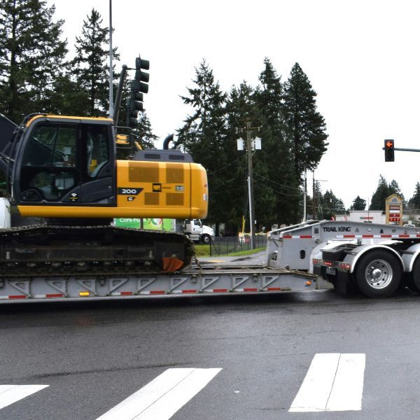 Tow truck towing construction equipment