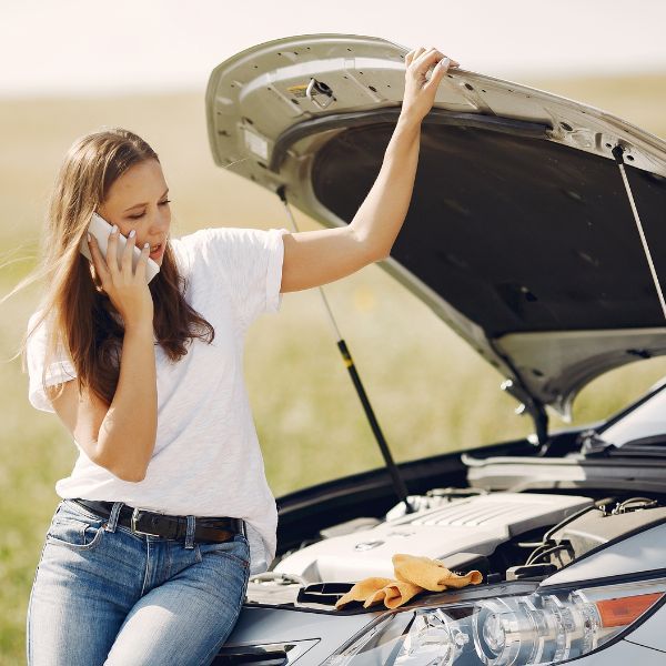 Woman with broken down car