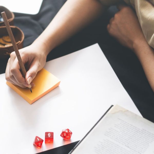 hand taking notes during tabletop game