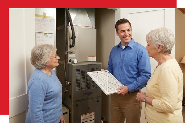 HVAC technician talking to ladies about a filter for furnace 