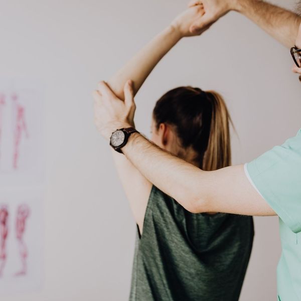 woman working with a physical therapist