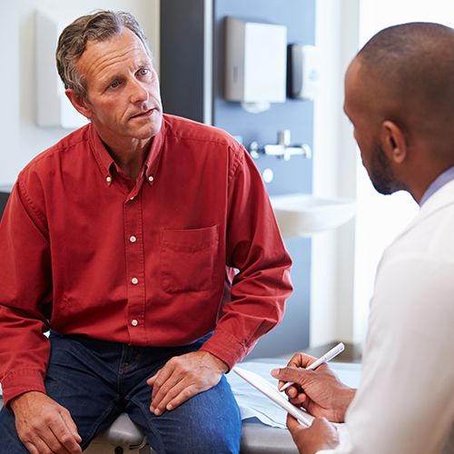 man speaking with doctor