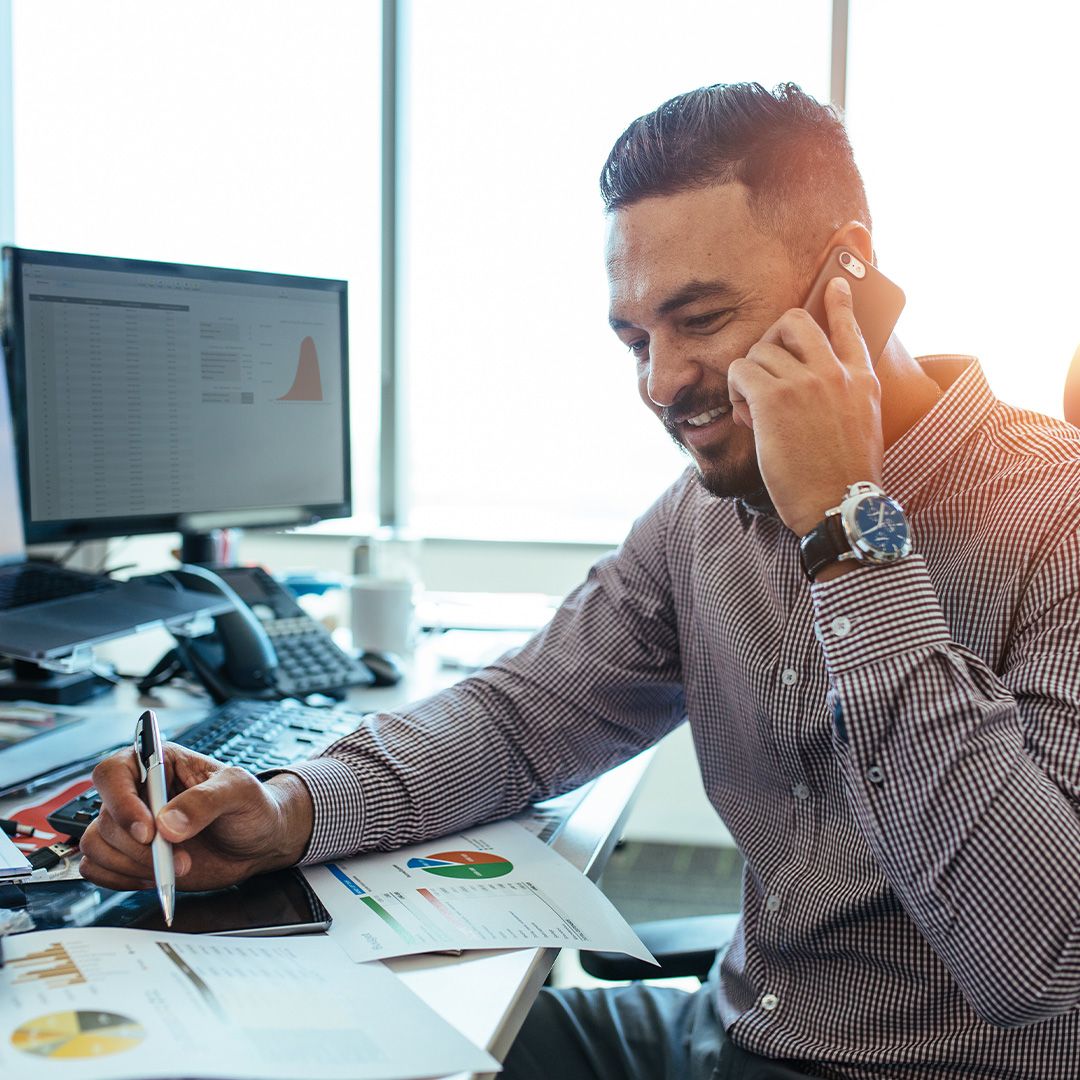 image of a smiling business man on the phone with support
