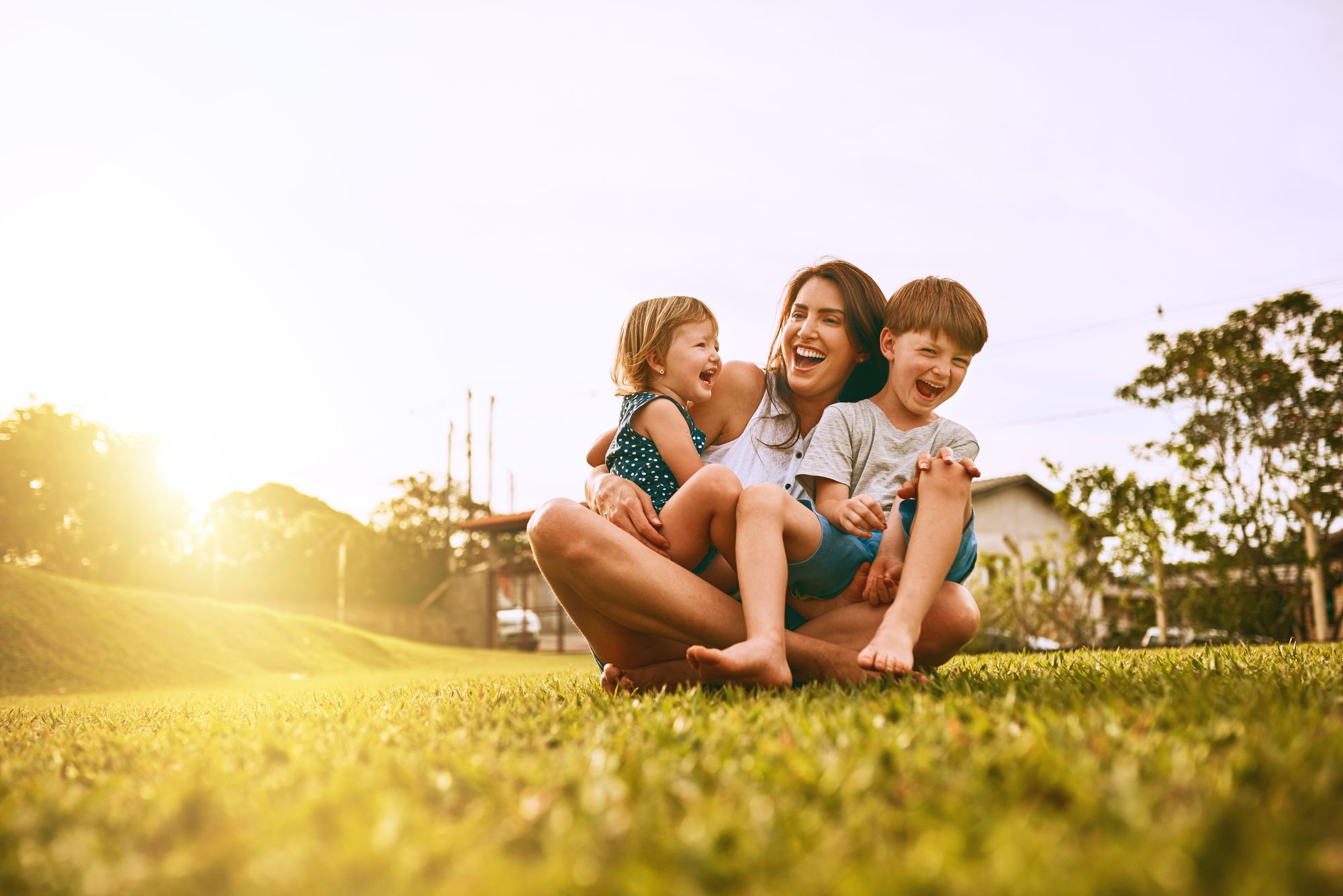 MOM WITH KIDS ON GRASS HAPPY.jpg
