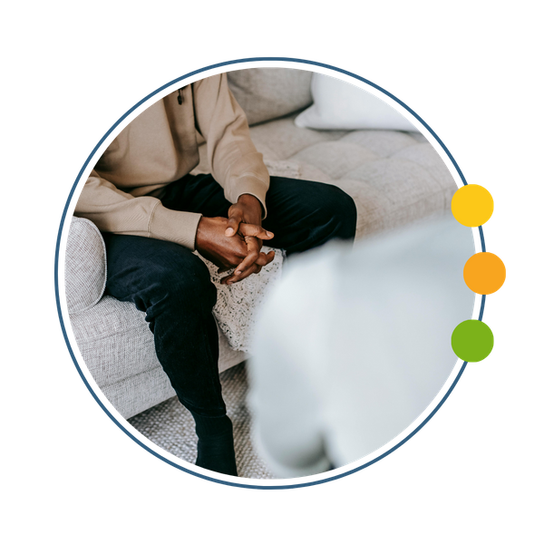 someone sitting on a couch across from a coach