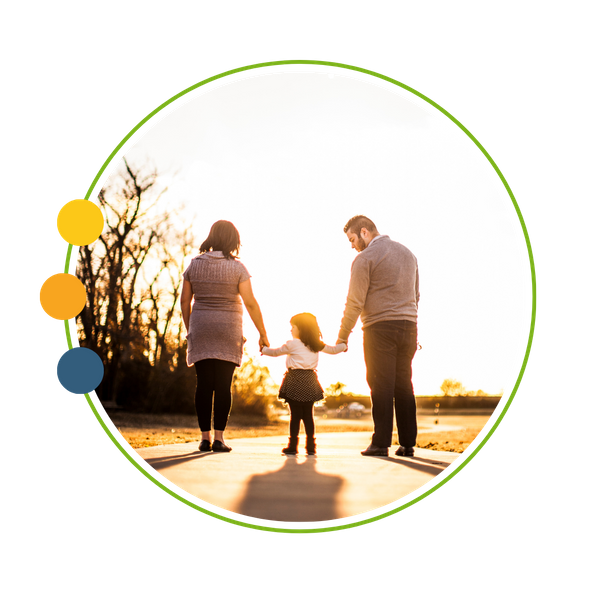 family holding hands walking on path