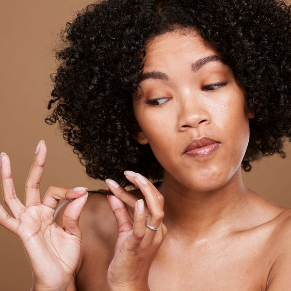 Woman looking at the ends of her hair