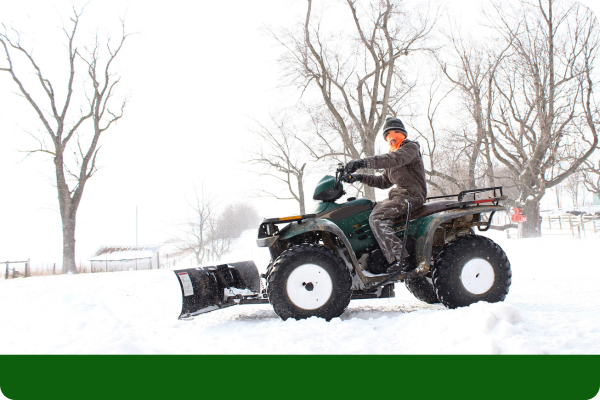 Man plowing snow on a residential property