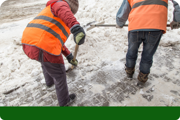 Workers removing snow from a walkway