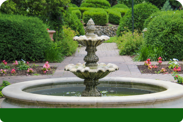 Two-tiered water fountain in a backyard