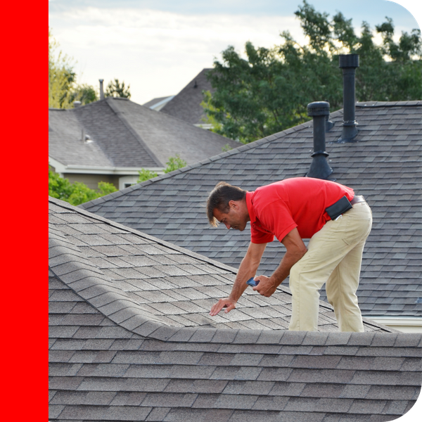 roofer in red shirt inspecting roof