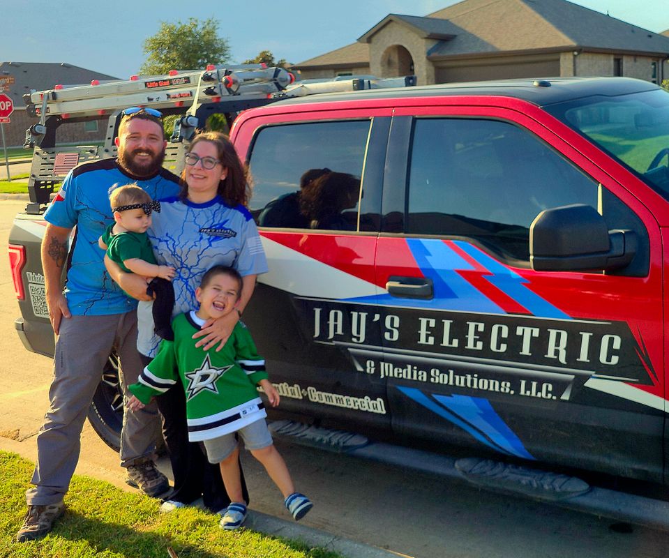 Jay's family in front of the JAY's Electric & Media Solutions company vehicle