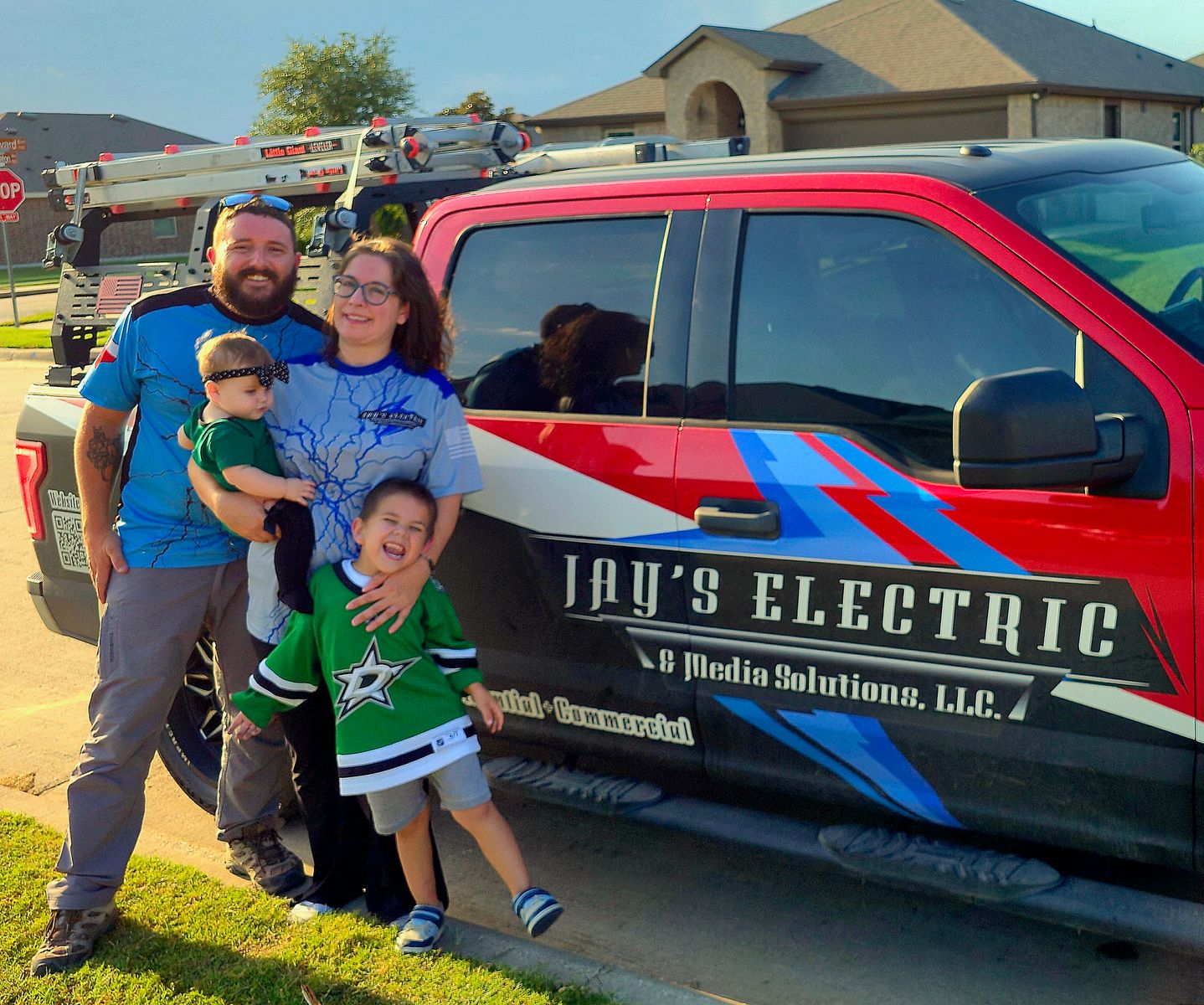 Jay's family in front of the JAY's Electric & Media Solutions company vehicle