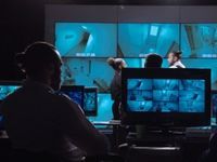 a man monitoring CCTV footage on monitors