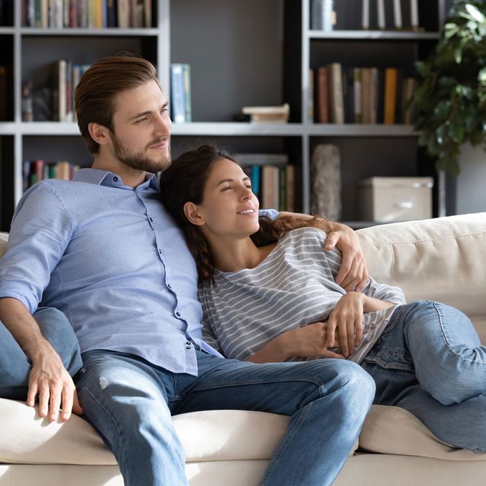  Image of a couple on a couch in a pest-free home. 