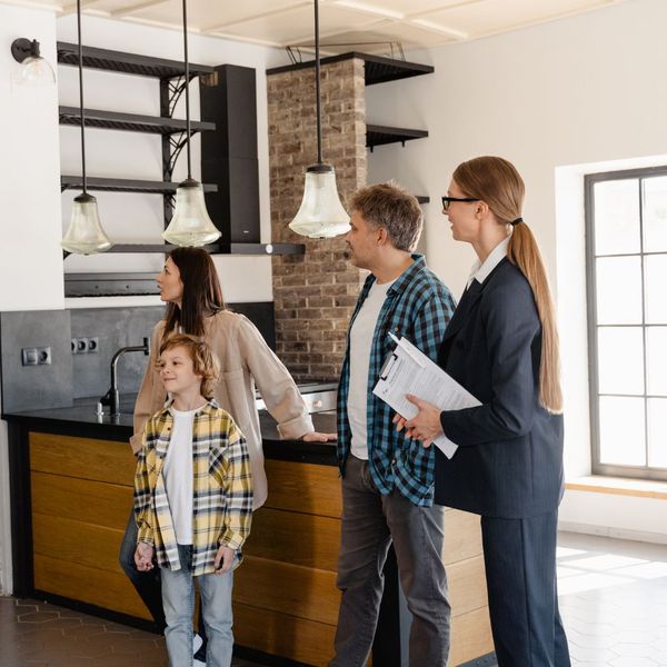 Real estate agent looking at a home with a family