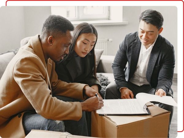 couple signing contract to buy home