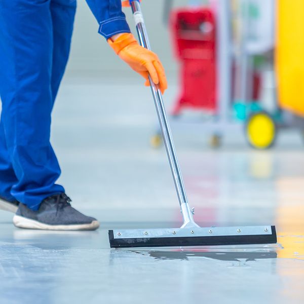 A man mopping the floor